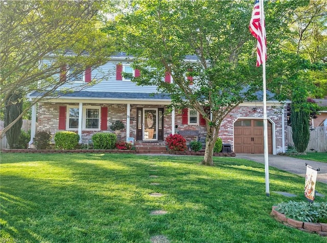 view of front of home with a garage, driveway, brick siding, and a front yard