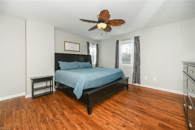 bedroom featuring a ceiling fan, baseboards, and wood finished floors