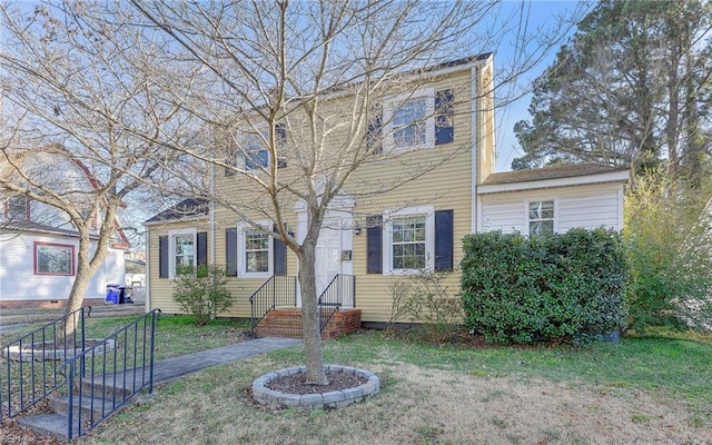 colonial-style house with a front yard