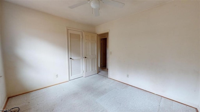 empty room with light carpet, ceiling fan, and baseboards