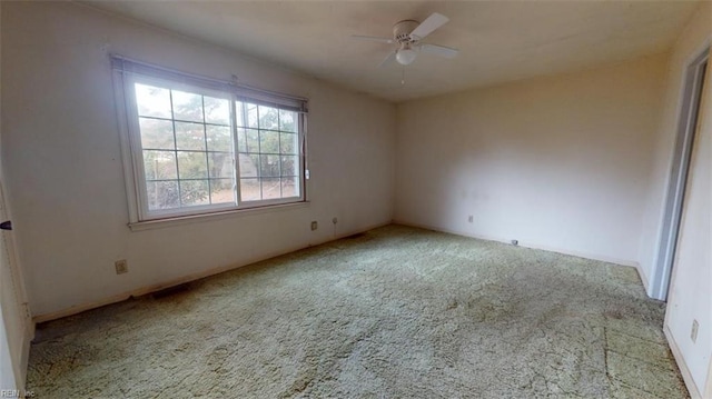 unfurnished room with light colored carpet and ceiling fan