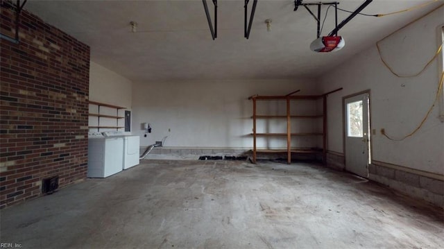 garage featuring a garage door opener and independent washer and dryer