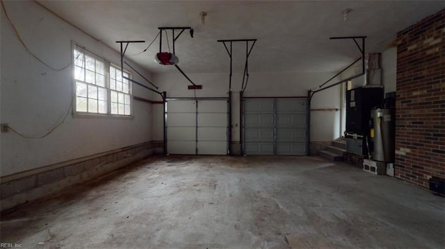 garage featuring water heater and a garage door opener