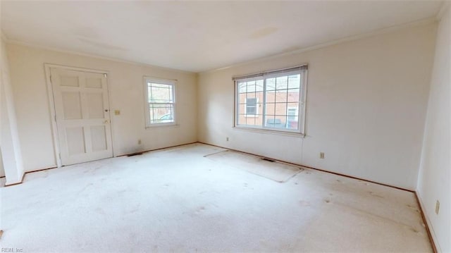 unfurnished room featuring a wealth of natural light and light colored carpet