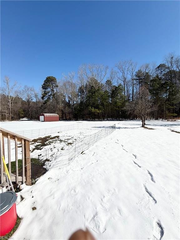 yard layered in snow with fence