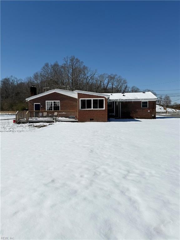 view of front of house with crawl space and brick siding