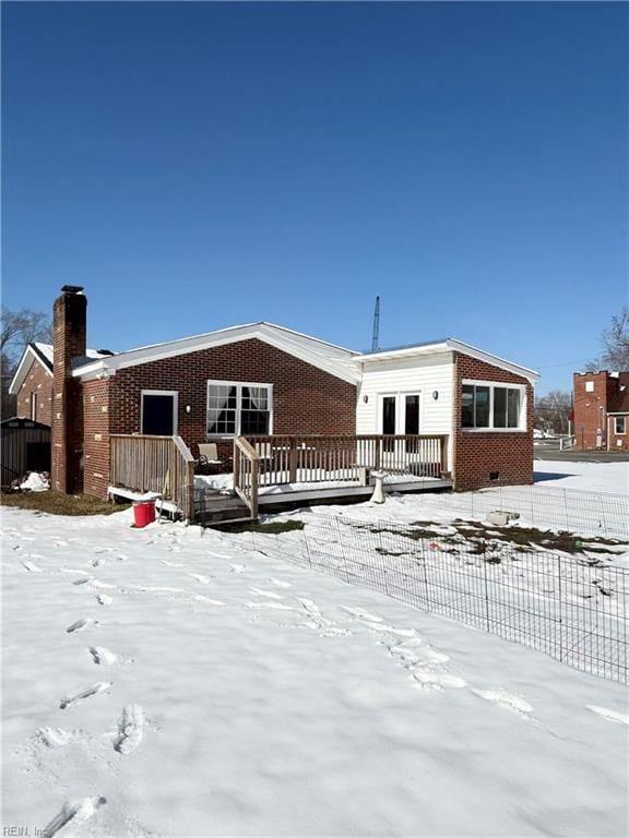 view of front of house featuring crawl space, fence, a deck, and brick siding