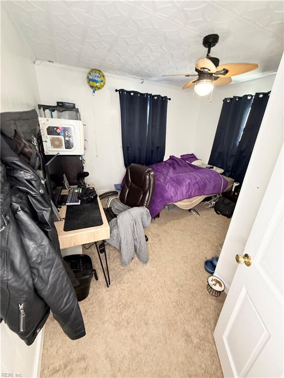 bedroom featuring ceiling fan and carpet flooring