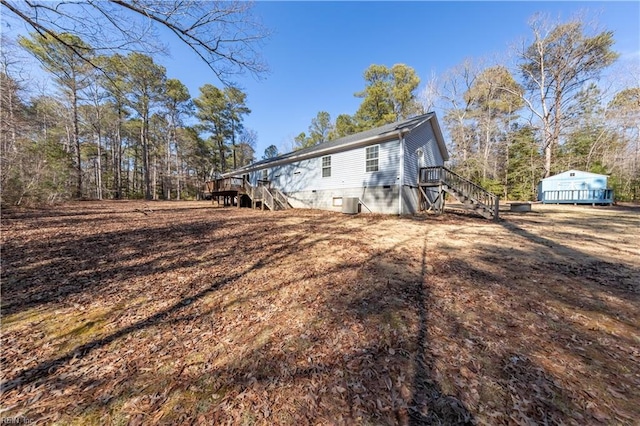 view of property exterior with stairway and crawl space