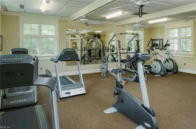 workout area featuring baseboards, plenty of natural light, a ceiling fan, and crown molding