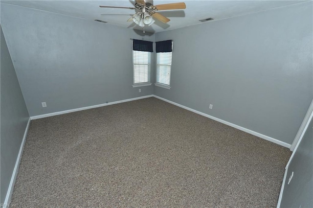 spare room featuring carpet floors, visible vents, ceiling fan, and baseboards