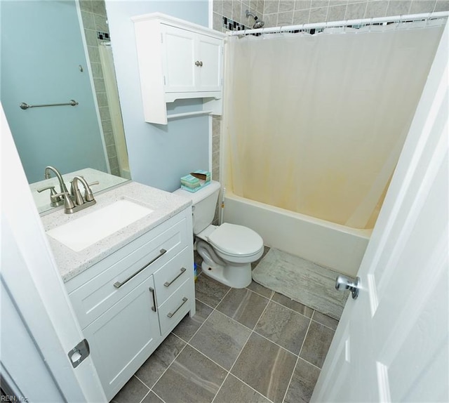 bathroom featuring toilet, shower / tub combo, and vanity