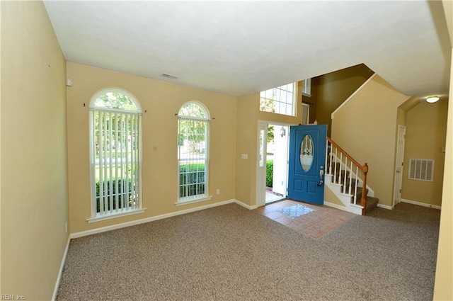 entryway featuring a healthy amount of sunlight, visible vents, and carpet flooring