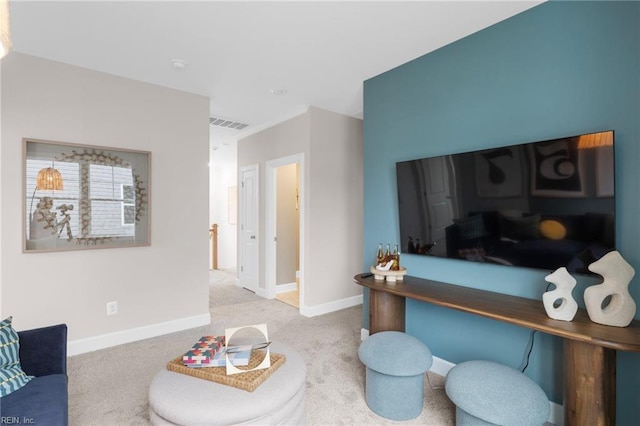 living room with baseboards, visible vents, and light colored carpet