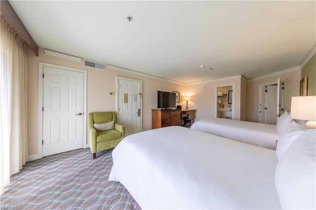 bedroom featuring light colored carpet, visible vents, crown molding, and ensuite bath