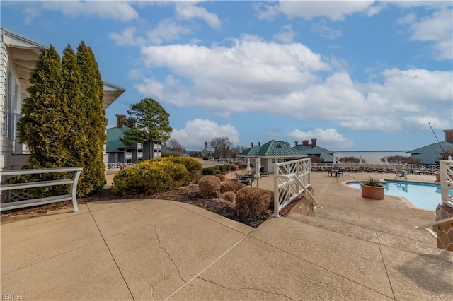 view of patio / terrace featuring a gazebo and a community pool