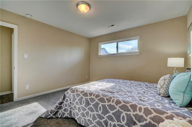 carpeted bedroom featuring visible vents and baseboards