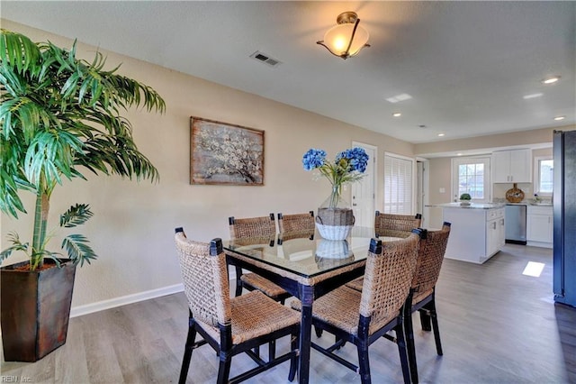 dining area featuring recessed lighting, wood finished floors, visible vents, and baseboards