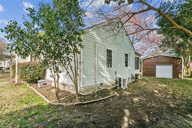 view of home's exterior featuring an outbuilding, a garage, and central air condition unit