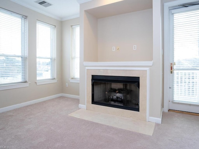 interior details with visible vents, ornamental molding, carpet flooring, and a tile fireplace