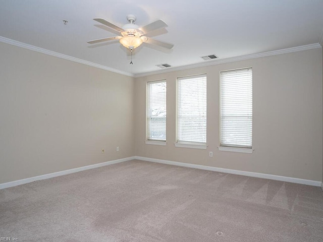 unfurnished room featuring ornamental molding, visible vents, and baseboards