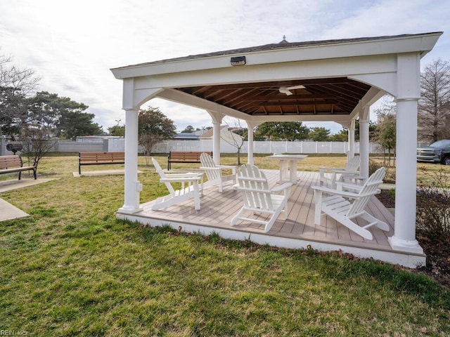 exterior space with ceiling fan, a gazebo, and fence