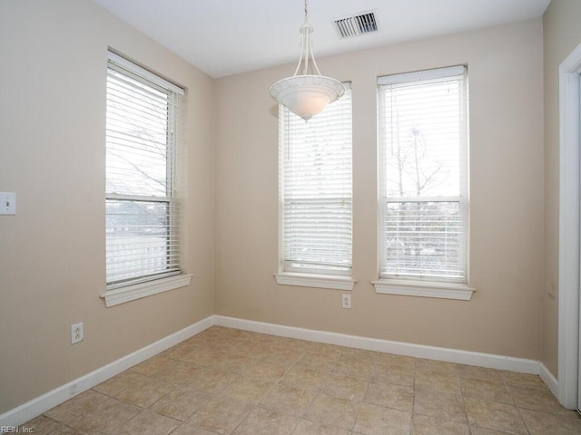 unfurnished dining area with visible vents and baseboards