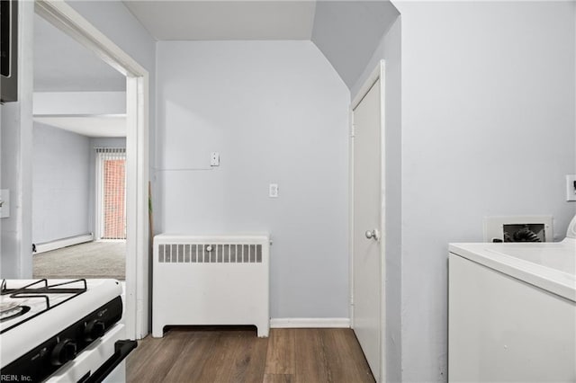 laundry room with laundry area, dark wood-type flooring, baseboard heating, radiator, and washer / dryer