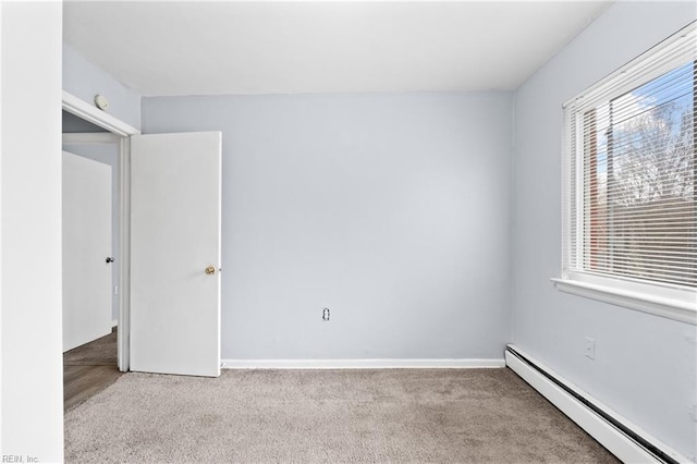 unfurnished bedroom featuring a baseboard radiator, light carpet, and baseboards