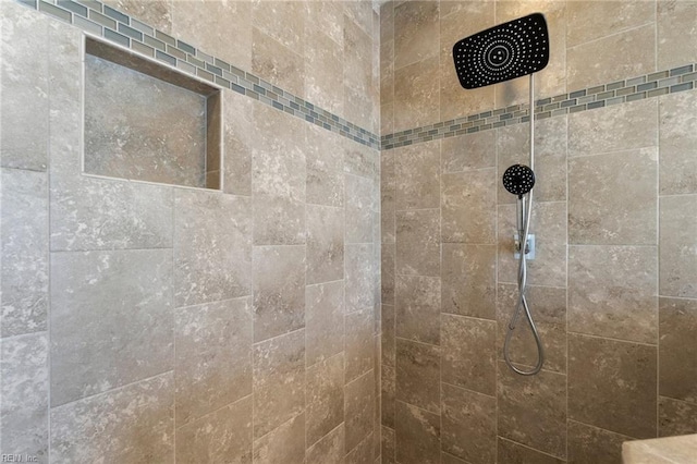 interior details featuring a tile shower