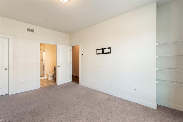 unfurnished bedroom with light carpet, a closet, visible vents, and baseboards