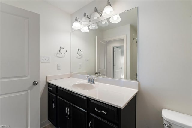 bathroom with toilet and vanity