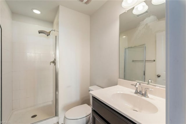 full bathroom with visible vents, vanity, toilet, and a shower stall