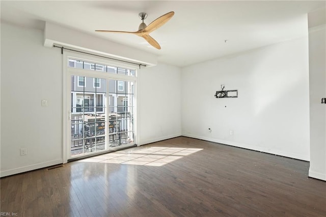 unfurnished room with a ceiling fan, baseboards, and wood finished floors