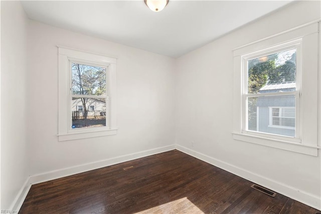 spare room featuring baseboards, visible vents, and a healthy amount of sunlight