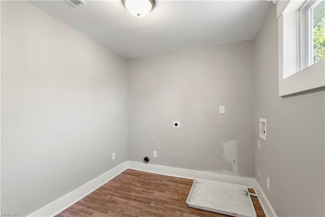 laundry room featuring hookup for a washing machine, laundry area, wood finished floors, baseboards, and electric dryer hookup