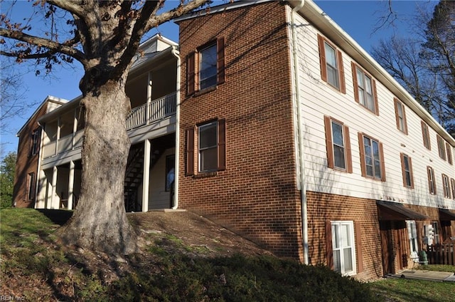 view of side of property featuring brick siding