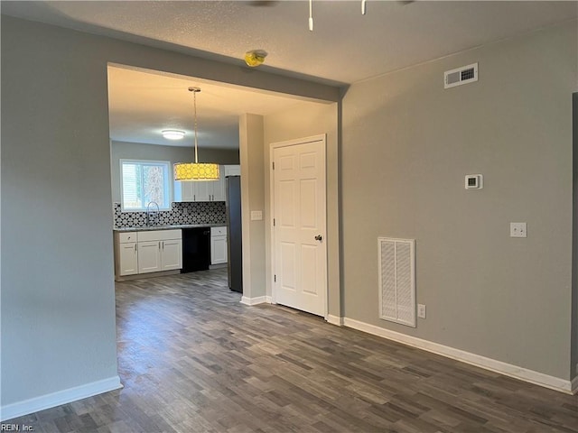 211 Central Ave, Suffolk, VA 23434 - empty room with baseboards, visible vents, and dark wood-style flooring