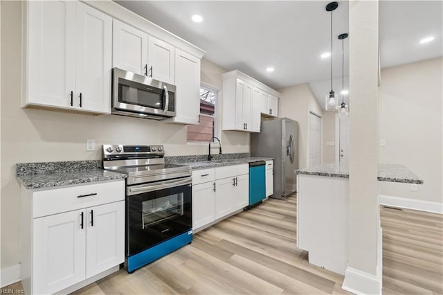 kitchen featuring white cabinets, appliances with stainless steel finishes, light wood-type flooring, pendant lighting, and recessed lighting