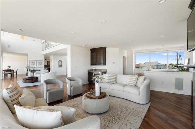 living room featuring dark wood finished floors, visible vents, and recessed lighting