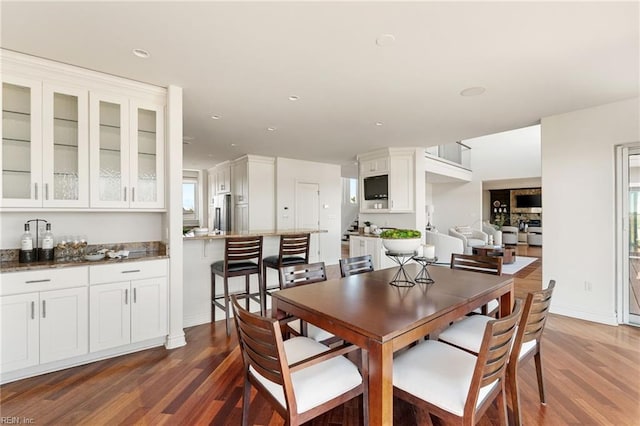 dining room with baseboards, dark wood finished floors, stairs, and recessed lighting