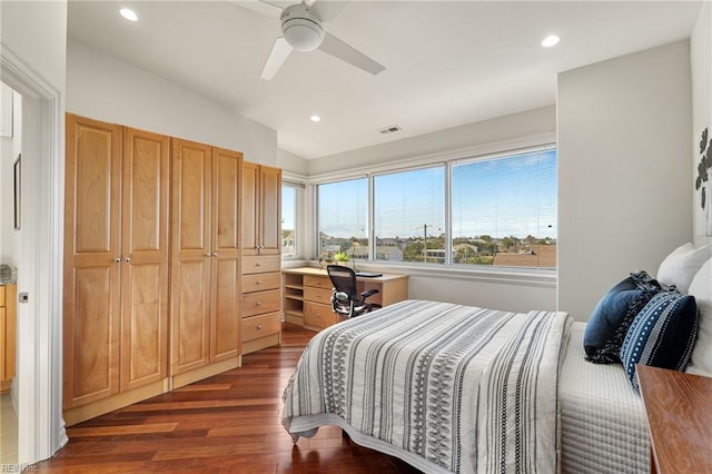 bedroom featuring visible vents, dark wood finished floors, lofted ceiling, built in desk, and recessed lighting