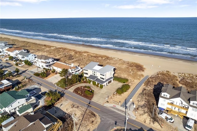 birds eye view of property featuring a view of the beach and a water view