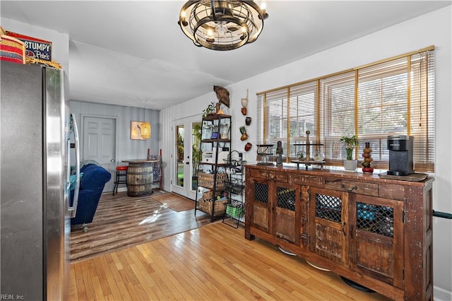 office area featuring french doors, a notable chandelier, and wood finished floors