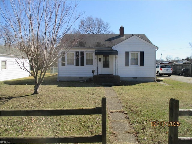 view of front of house featuring crawl space, a chimney, fence, and a front lawn