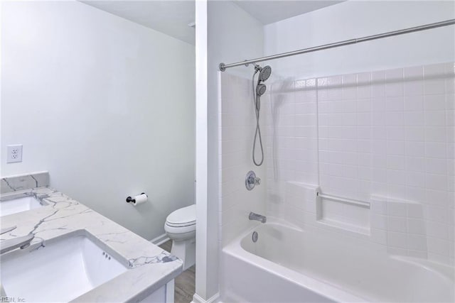 bathroom featuring double vanity, tub / shower combination, a sink, and toilet