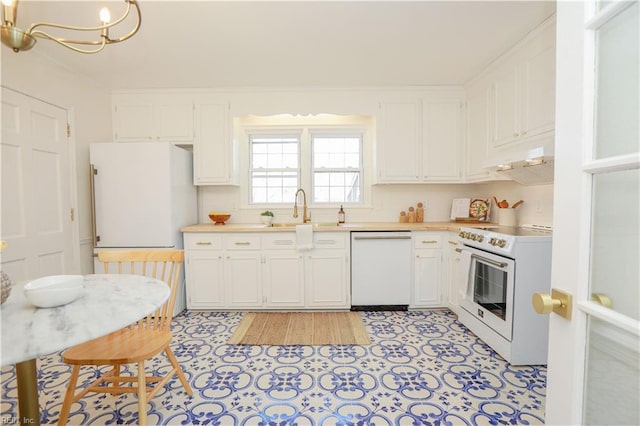 kitchen with light countertops, white appliances, under cabinet range hood, and white cabinets