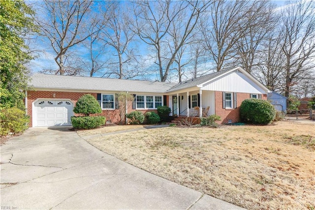 ranch-style home with a porch, a garage, brick siding, concrete driveway, and crawl space