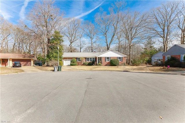 ranch-style home featuring an attached garage and concrete driveway