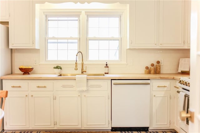 kitchen featuring light countertops, white appliances, a sink, and white cabinets